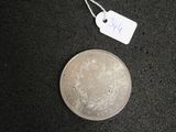 a small silver coin with a price tag on it