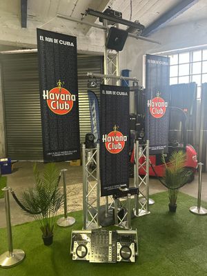 two speakers on a stand in the middle of a room