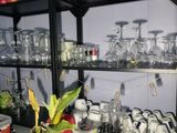 bottles and glasses on a shelf in a room with a lot of bottles