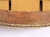 a close up view of a wooden chair with a woven seat