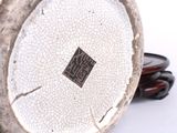 a close up of a silver vase with a cracky surface