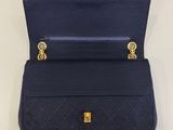 a close up of a blue purse hanging on a wall