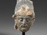 an image of a head of a man wearing a headdress