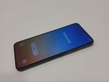 a close up of a phone on a table with a blurry background