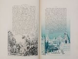 an open book with a picture of a town in it