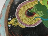 a picture of a dragon painted on the side of a vase