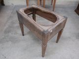 a wooden table with a toilet in it on the floor