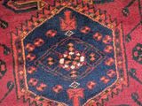 an image of a red and blue rug with a diamond design on it