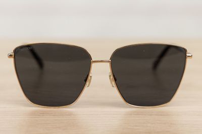 a pair of sunglasses sitting on top of a wooden table