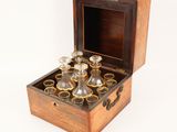 a wooden box that has a set of glasses in it