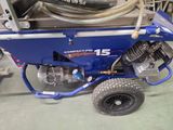 a blue machine with a hose attached to it