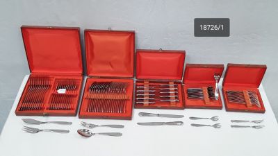 many different types of silverware in a red case