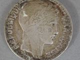 a close up of a silver coin with a woman ' s head on it