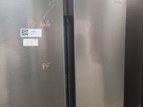two refrigerators that are side by side in the kitchen