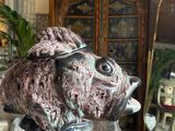 a statue of a fish sitting on top of a glass table