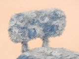 a sheep that is standing on top of a chair