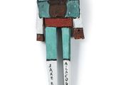a figurine of a man with a flower pot on his head