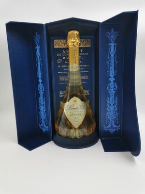 une boîte bleue ouverte contenant une bouteille de champagne