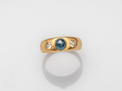 an image of a gold ring with a blue sapphire and diamonds