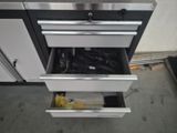 a metal drawer that has a bunch of tools in it