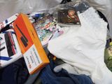 a suitcase full of clothing and a computer on the bed