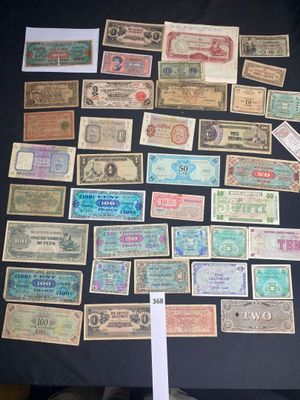 several different types of paper money are displayed on a table