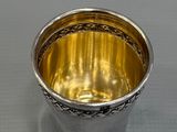 a silver cup that is sitting on a table