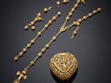 a gold and diamond necklace, bracelet, and broochle