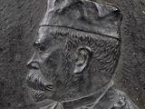 a statue of a man wearing a hat and a tie