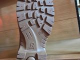 a close up of a person ' s shoe on a desk