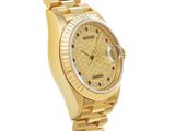 a close up of a watch on a gold bracelet on a white background