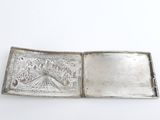 an old silver plate with a picture of a castle on it