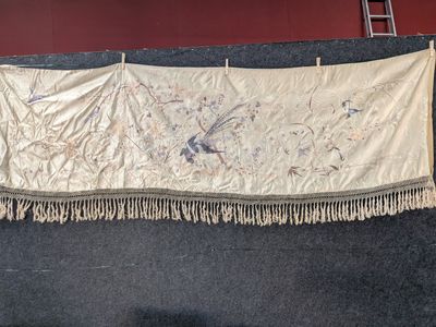 a large white cloth hanging on a wall