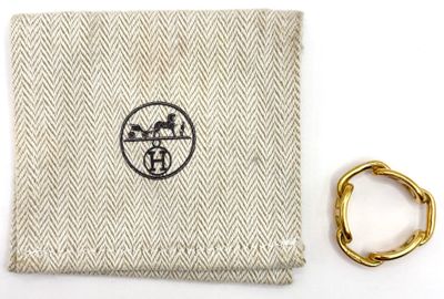 beige and white cloth with a gold ring and a ring on it