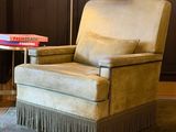 a chair and a table in a room with wood paneled walls