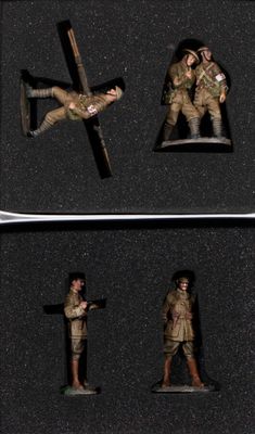 four figurines of soldiers in a black box