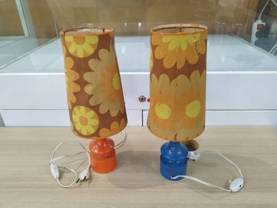 two lamps that are sitting on a wooden table