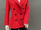 the mannequin is wearing a red jacket and black pants