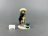 a figurine of a man with a hat and a cane