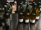 bottles of wine are lined up on a table in a restaurant