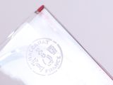 a person holding a piece of paper with a stamp on it