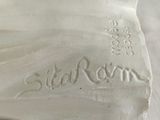 a close up of a white ceramic sculpture of a shell