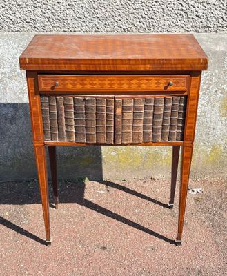 a small wooden table with a basket on top of it