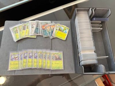 some baseball cards are sitting in a metal box on a table