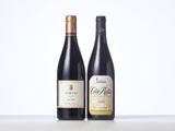 two bottles of wine sit side by side on a table