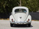a white vw beetle parked in a parking lot