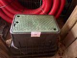 a plastic box with a red hose on top of it