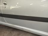 a white car with a black stripe on the side of it