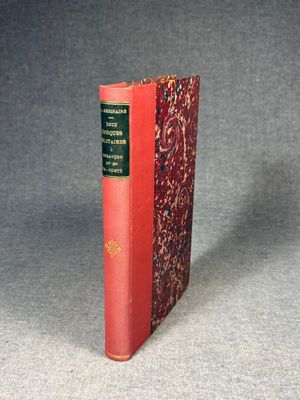 a red book sitting on top of a table next to a gray wall