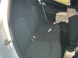 the back seat of a car with the door open and the seat belt down